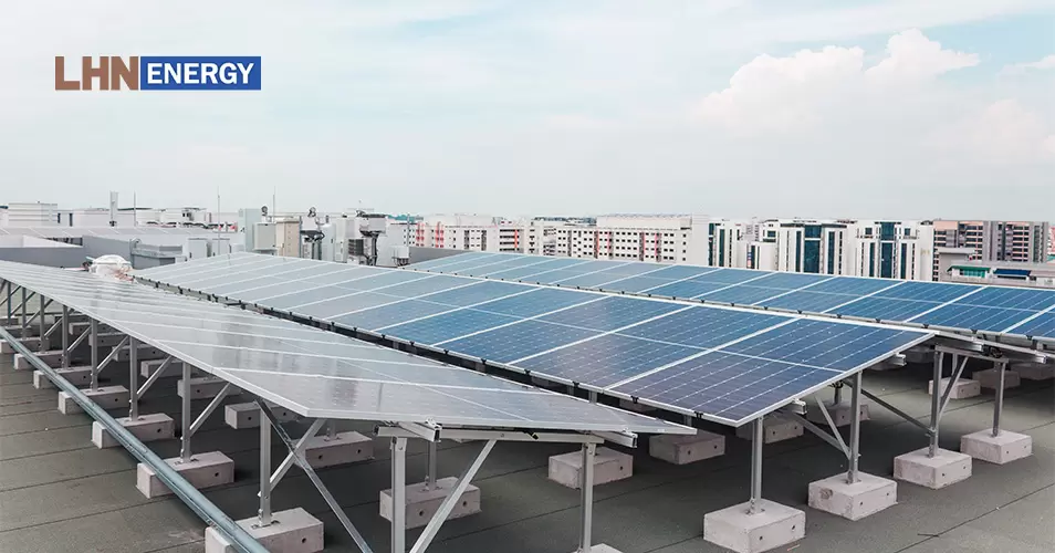 Rows of commercial solar panels installed on a rooftop.
