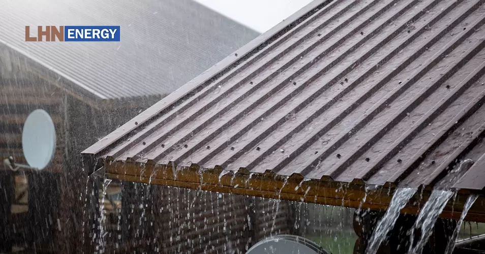 Heavy rain falling on a metal roof, highlighting maintenance needs.